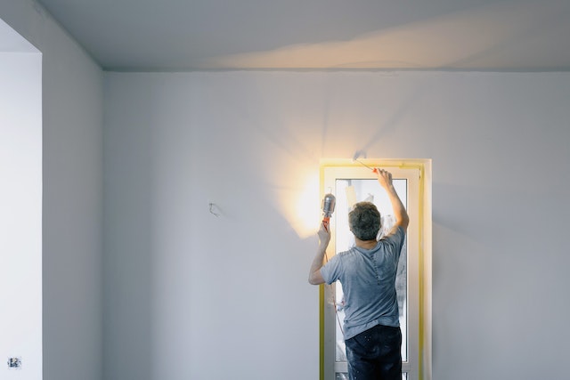 repairing a door with a screwdriver and a light